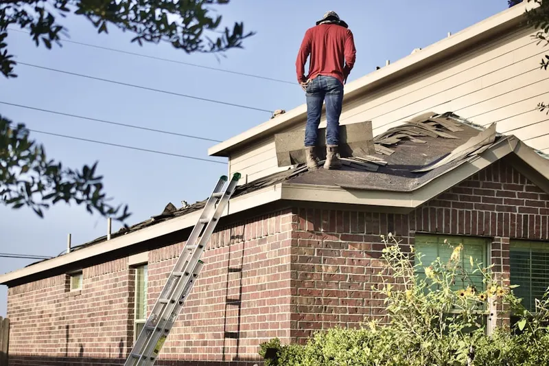 Professional roofer working on a residential roof in McSwain